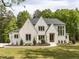 Stunning white brick home with manicured lawn, mature trees, and elegant design at 40 Ridgeline Ct # 10, Pittsboro, NC 27312