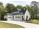 Charming two-story home featuring a well-manicured lawn, a long driveway, and a three-car garage at 40 Ridgeline Ct # 10, Pittsboro, NC 27312