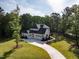 Stunning traditional home with a three car garage on a manicured lawn and driveway at 40 Ridgeline Ct # 10, Pittsboro, NC 27312