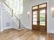 Bright foyer with hardwood floors, grand staircase, and stylish lighting fixtures at 40 Ridgeline Ct # 10, Pittsboro, NC 27312