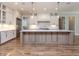 Spacious kitchen with large island, white cabinets, stainless appliances, and hardwood floors at 40 Ridgeline Ct # 10, Pittsboro, NC 27312