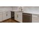 Modern kitchen features white cabinets, quartz counters, wine cooler and stainless steel dishwasher at 40 Ridgeline Ct # 10, Pittsboro, NC 27312
