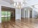 Spacious living room with hardwood floors, elegant chandelier, and natural light at 40 Ridgeline Ct # 10, Pittsboro, NC 27312