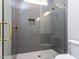Modern shower with glass enclosure, gray tile, gold fixtures, shower niche and rain showerhead at 40 Ridgeline Ct # 10, Pittsboro, NC 27312
