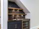 A charming wet bar features stylish shelving, a sink, and a built-in beverage cooler at 40 Ridgeline Ct # 10, Pittsboro, NC 27312