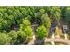 Home with long driveway surrounded by lush, mature trees in a quiet neighborhood at 4005 Colleen Way, Kittrell, NC 27544