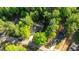 Home with long driveway surrounded by lush, mature trees in a quiet neighborhood at 4005 Colleen Way, Kittrell, NC 27544