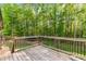 Spacious wooden back deck offers a tranquil outdoor space with lovely views of the lush, green backyard at 4005 Colleen Way, Kittrell, NC 27544