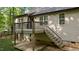 Back deck featuring wood stairs and black metal railing at 4005 Colleen Way, Kittrell, NC 27544
