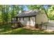 Backyard featuring a deck, grassy lawn, trees and a fence at 4005 Colleen Way, Kittrell, NC 27544