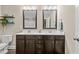 Bathroom with double sink vanity, quartz countertop, dark wood cabinets, and decorative mirrors at 4005 Colleen Way, Kittrell, NC 27544