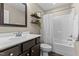 Bathroom with dark vanity, tub and shower combo, and decorative shelves at 4005 Colleen Way, Kittrell, NC 27544