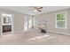 Spacious bedroom featuring neutral walls, carpet, ceiling fan, and natural light from two windows at 4005 Colleen Way, Kittrell, NC 27544