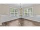 Dining room with natural light, chandelier, wainscotting and wood flooring at 4005 Colleen Way, Kittrell, NC 27544
