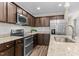 Kitchen featuring stainless steel appliances, granite counters and dark cabinetry at 4005 Colleen Way, Kittrell, NC 27544