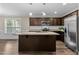 Kitchen with stainless steel appliances, island, granite countertops, and dark cabinets at 4005 Colleen Way, Kittrell, NC 27544