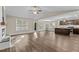 Open-concept living room featuring fireplace, ceiling fan, and a view of the kitchen at 4005 Colleen Way, Kittrell, NC 27544