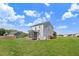 Expansive backyard featuring green grass and a screened-in porch, perfect for outdoor enjoyment at 47 Peduncle St, Selma, NC 27576