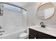 Bathroom with shower-tub combo, modern fixtures, decorative mirror and a white vanity at 47 Peduncle St, Selma, NC 27576
