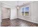 Bright dining room with wood floors, large window, and modern chandelier at 47 Peduncle St, Selma, NC 27576