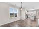 Bright, open-concept kitchen featuring stainless steel appliances, white cabinetry, and wood flooring at 47 Peduncle St, Selma, NC 27576