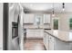 Kitchen with granite countertops, white cabinets, and stainless steel appliances at 47 Peduncle St, Selma, NC 27576