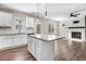 Spacious kitchen featuring a large island, stainless steel appliances, and fireplace at 47 Peduncle St, Selma, NC 27576