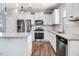 Beautiful kitchen featuring white cabinets, stainless steel appliances, and stone countertops at 47 Peduncle St, Selma, NC 27576