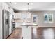Open-concept kitchen featuring a center island, stainless steel appliances, and modern pendant lighting at 47 Peduncle St, Selma, NC 27576