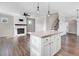 Open floor plan with a kitchen island, fireplace, and staircase at 47 Peduncle St, Selma, NC 27576