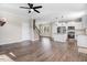 Open-concept living space featuring hardwood floors, white cabinets, and a staircase at 47 Peduncle St, Selma, NC 27576