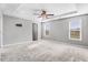 Spacious bedroom featuring a tray ceiling, a ceiling fan, plush carpet, and ample natural light at 47 Peduncle St, Selma, NC 27576
