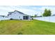 Expansive backyard showcases a lush lawn, screened patio, and a full privacy fence at 49 Kathy Mae Ct, Angier, NC 27501
