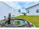 Landscaped backyard featuring a charming lily pond and a pristine white fence at 49 Kathy Mae Ct, Angier, NC 27501