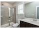 Bathroom features a shower, dark cabinets, a large mirror, and bright natural light at 49 Kathy Mae Ct, Angier, NC 27501