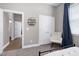 Neutral colored bedroom with double doors, rocking chair, and adjacent hallway and bedroom at 49 Kathy Mae Ct, Angier, NC 27501