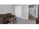 Cozy bedroom with neutral walls, a plush sofa, and double doors at 49 Kathy Mae Ct, Angier, NC 27501