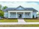 Inviting clubhouse with a gray exterior, white columns, and manicured landscaping at 49 Kathy Mae Ct, Angier, NC 27501