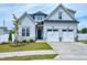 Charming two-story home with manicured lawn, two-car garage, and neutral-colored exterior at 49 Kathy Mae Ct, Angier, NC 27501