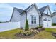Well-maintained home featuring flower beds, a white fence, and a two-car garage at 49 Kathy Mae Ct, Angier, NC 27501