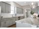 Bright kitchen features gray cabinets, granite countertops, stainless appliances, and hardwood floors at 49 Kathy Mae Ct, Angier, NC 27501