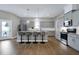 Bright kitchen features gray cabinets, granite countertops, stainless appliances, and hardwood floors at 49 Kathy Mae Ct, Angier, NC 27501