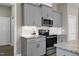 Modern kitchen has gray cabinetry, stainless appliances, and subway tile backsplash at 49 Kathy Mae Ct, Angier, NC 27501