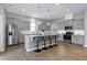 Bright kitchen features gray cabinets, granite countertops, stainless appliances, and hardwood floors at 49 Kathy Mae Ct, Angier, NC 27501