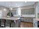 Bright kitchen features gray cabinets, granite countertops, stainless appliances, and hardwood floors at 49 Kathy Mae Ct, Angier, NC 27501