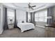 Bright and airy main bedroom featuring tray ceiling, neutral tones, and large windows at 49 Kathy Mae Ct, Angier, NC 27501