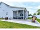 Covered and screened patio area with fan, dining table, and BBQ, adjacent to a large grassy yard at 49 Kathy Mae Ct, Angier, NC 27501