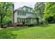 Spacious backyard view showcasing a deck, chimney, and well-maintained lawn and garden at 5112 Wolcott Ct, Fuquay Varina, NC 27526
