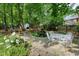 Beautiful backyard oasis with a stone patio, water feature, and lush landscaping at 5112 Wolcott Ct, Fuquay Varina, NC 27526