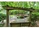 Relaxing backyard with a pergola swing, water feature, and stone patio at 5112 Wolcott Ct, Fuquay Varina, NC 27526